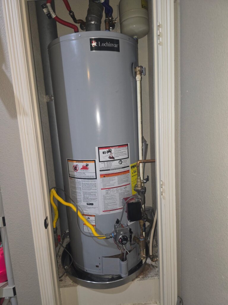 Lochinvar gas water heater installed in a closet with yellow gas line, copper pipes, and expansion tank above